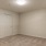 Spacious and well lit bedroom with plush carpet