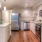 Spacious kitchen with island and stainless steel apliances