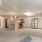 Spacious and well lit living room with large open floor plan and access to kitchen