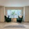 Spacious and well lit living room with large windows adjacent to the kitchen