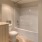 Large and well lit bathroom with large mirror
