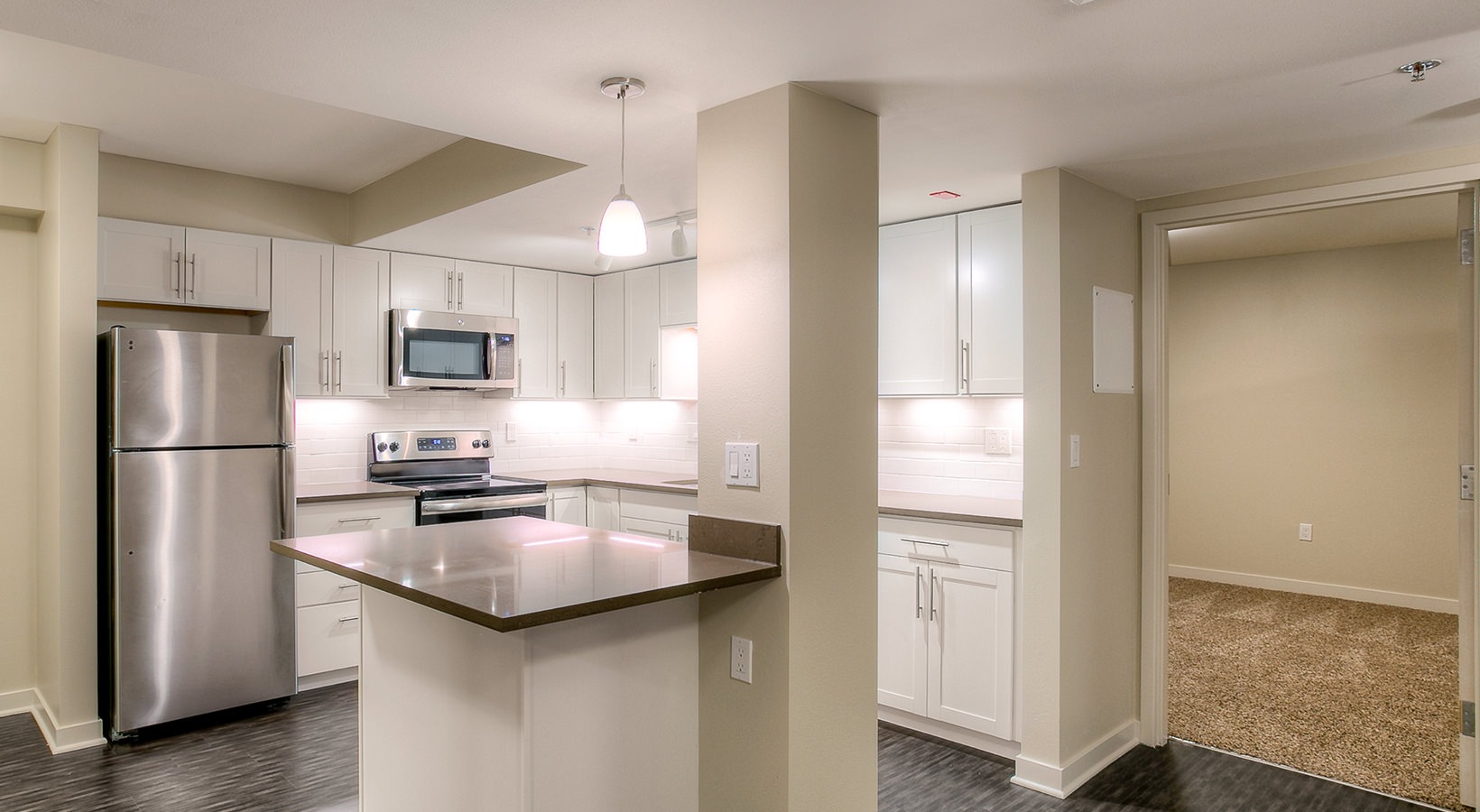 Kitchen Spacious well lit kitchen with an island and whit cabinets
